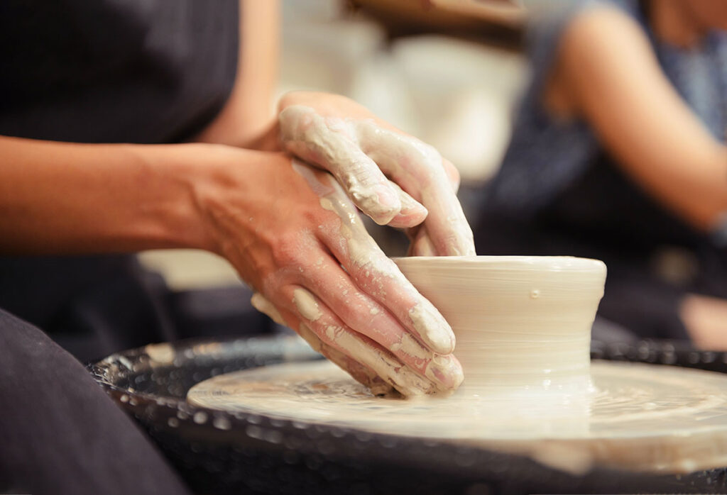 A person takes up pottery as a coping mechanism during alcohol addiction recovery